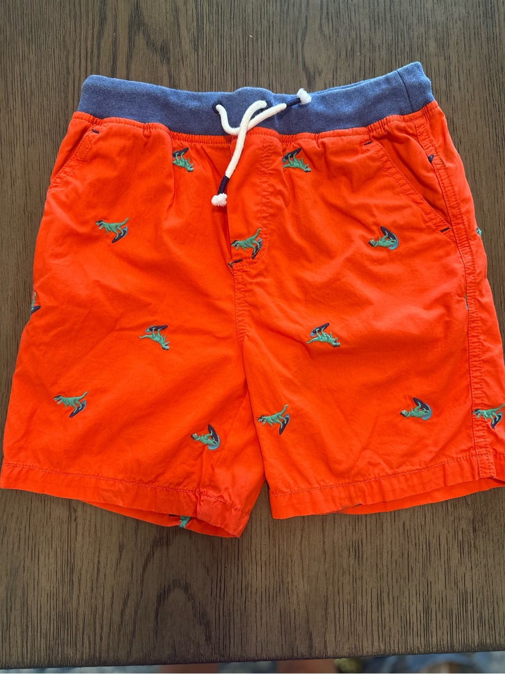 Mini Boden boys Orange dinosaur Shorts with Navy Waistband
